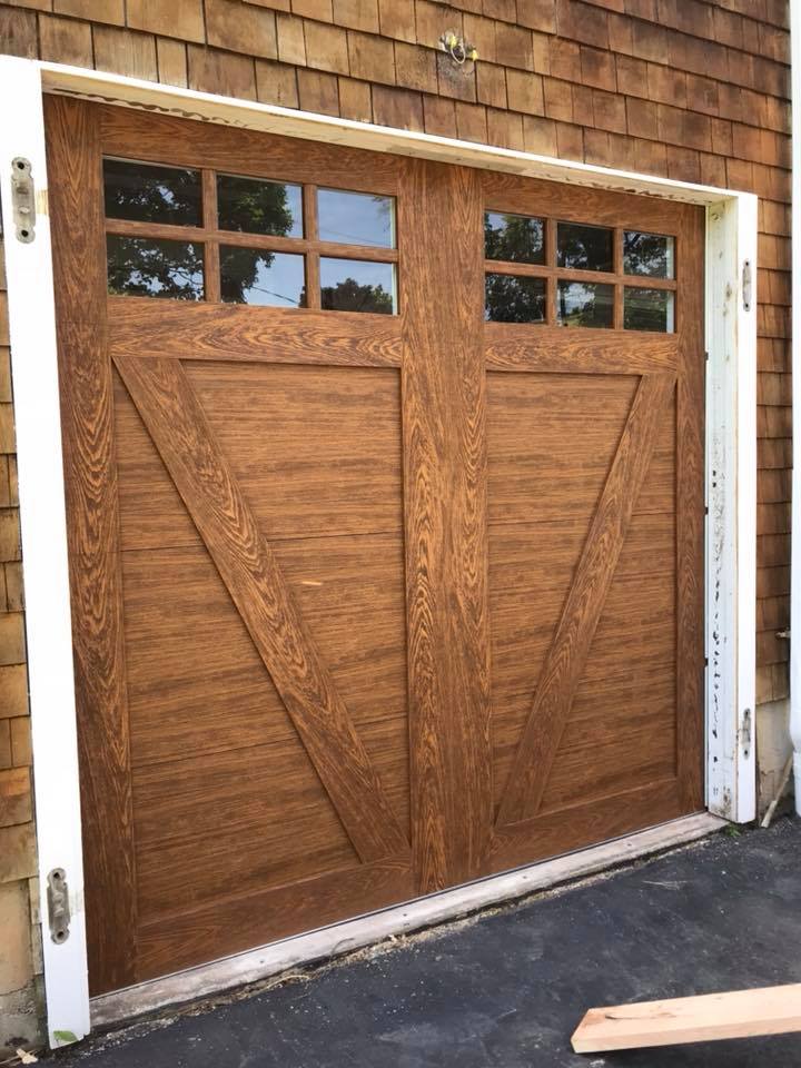 Clopay Canyon Ridge Collection in a medium wood grain tone installed in Cheshire, CT by Absolute Garage Doors