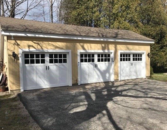 Fimbel American Legend garage door with a wide glass section and black decorative handles installed in Southington, CT by Absolute Garage Doors