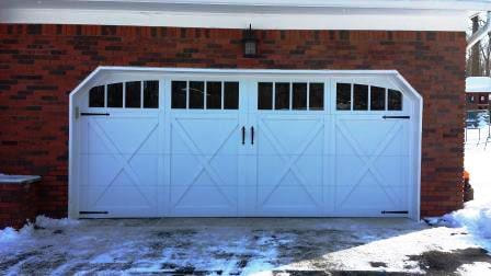 Carriage house double garage door in x-brace design with rectangular windows