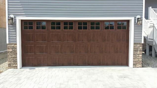 Steel raised panel garage door, short panel, stockton windows, in walnut wood grain color