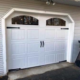 Clopay Bead board short panel garage door with black decorative hardware and plain arch glass windows