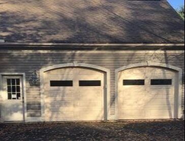 Raised long panel garage door with plain windows in white